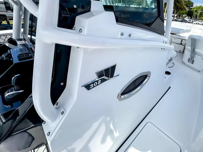  Yacht Photos Pics 2025 Wellcraft 302 Fisherman boat, sleek white exterior with modern design elements.