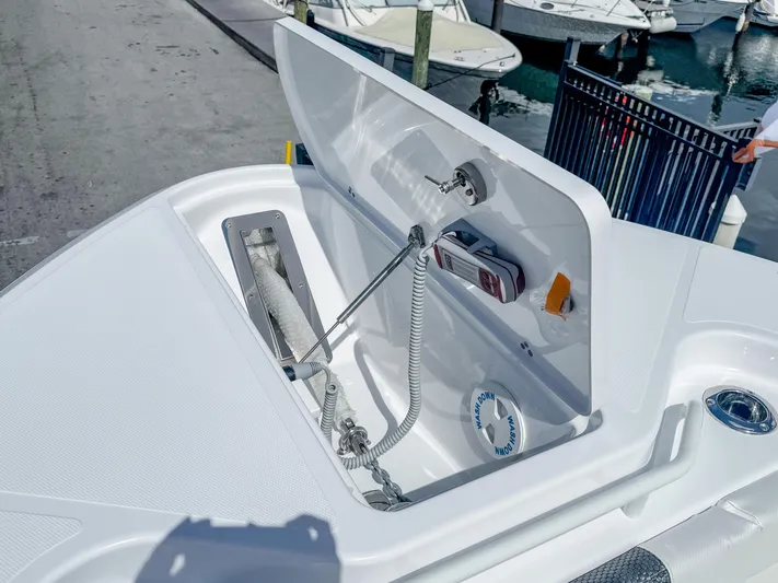  Yacht Photos Pics 2025 Wellcraft 302 Fisherman boat anchor compartment, open lid, docked at marina.