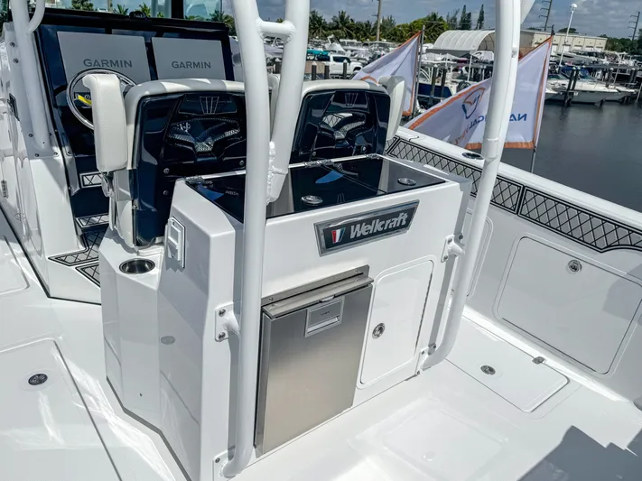  Yacht Photos Pics 2025 Wellcraft 302 Fisherman boat interior with Garmin displays and storage compartments.