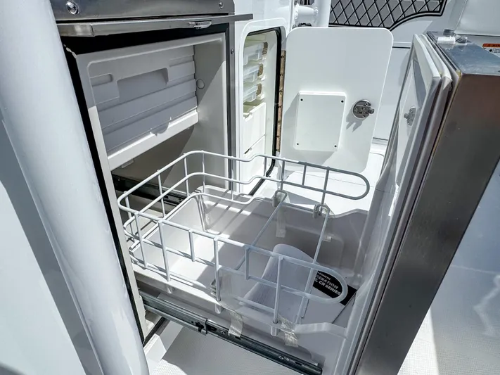  Yacht Photos Pics Open storage compartment on 2025 Wellcraft 302 Fisherman boat, featuring organized interior space.