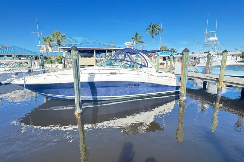  Yacht Photos Pics 2005 Sea Ray 340 Sundancer docked at marina under clear blue sky.