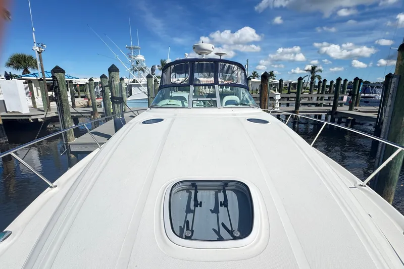  Yacht Photos Pics 2005 Sea Ray 340 Sundancer docked at marina under blue sky.