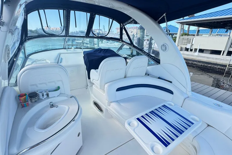  Yacht Photos Pics 2005 Sea Ray 340 Sundancer boat interior with white seating and a small sink.