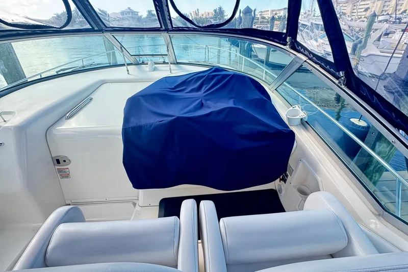  Yacht Photos Pics 2005 Sea Ray 340 Sundancer cockpit with blue cover, marina view.
