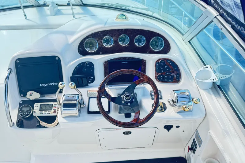  Yacht Photos Pics Cockpit of 2005 Sea Ray 340 Sundancer with steering wheel and navigation instruments.