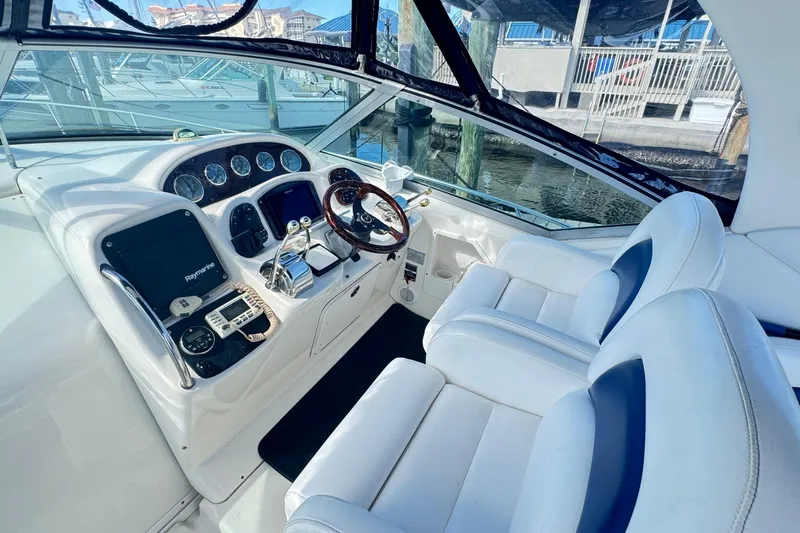  Yacht Photos Pics Cockpit of 2005 Sea Ray 340 Sundancer with modern navigation equipment and plush seating.