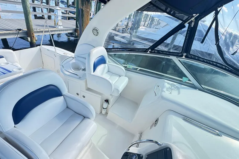  Yacht Photos Pics 2005 Sea Ray 340 Sundancer boat interior with white seating and helm station.