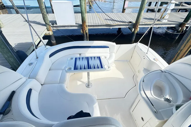  Yacht Photos Pics 2005 Sea Ray 340 Sundancer boat interior with seating and table at dock.