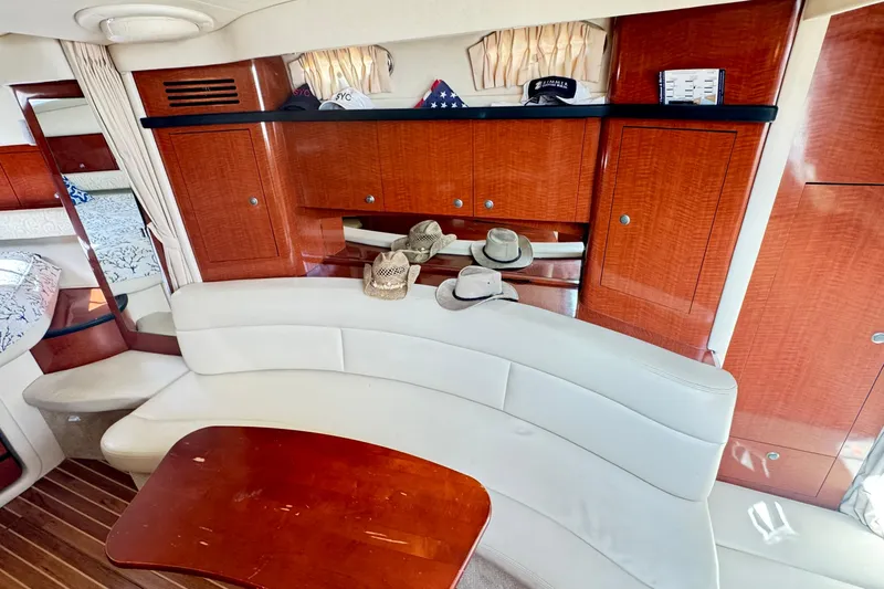  Yacht Photos Pics Interior of 2005 Sea Ray 340 Sundancer with elegant wood cabinetry and curved seating.