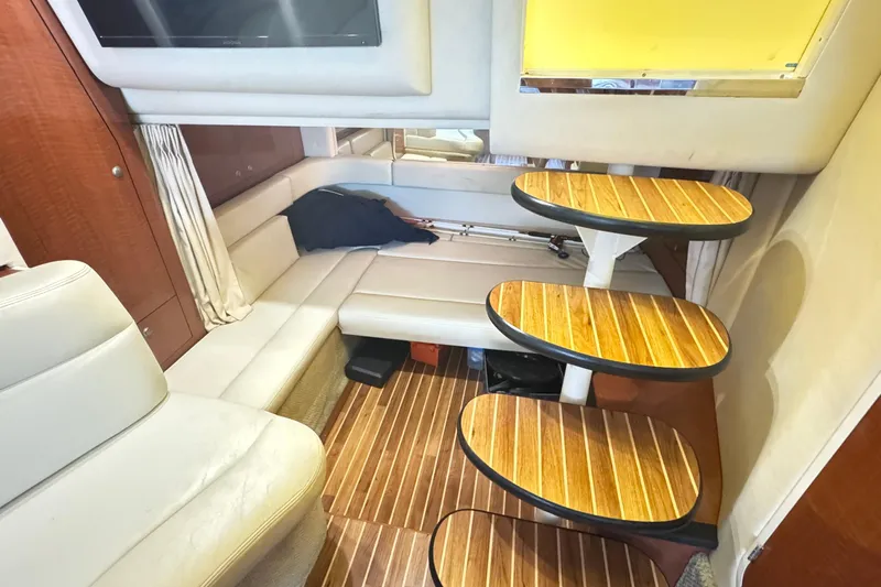  Yacht Photos Pics Interior of 2005 Sea Ray 340 Sundancer with wooden steps and cozy seating area.