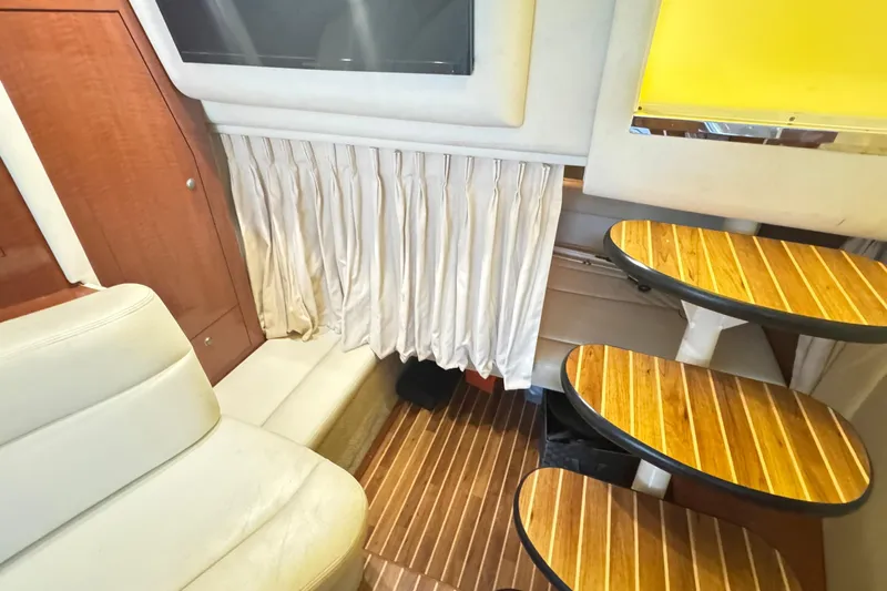  Yacht Photos Pics Interior of 2005 Sea Ray 340 Sundancer with wooden steps and white seating.
