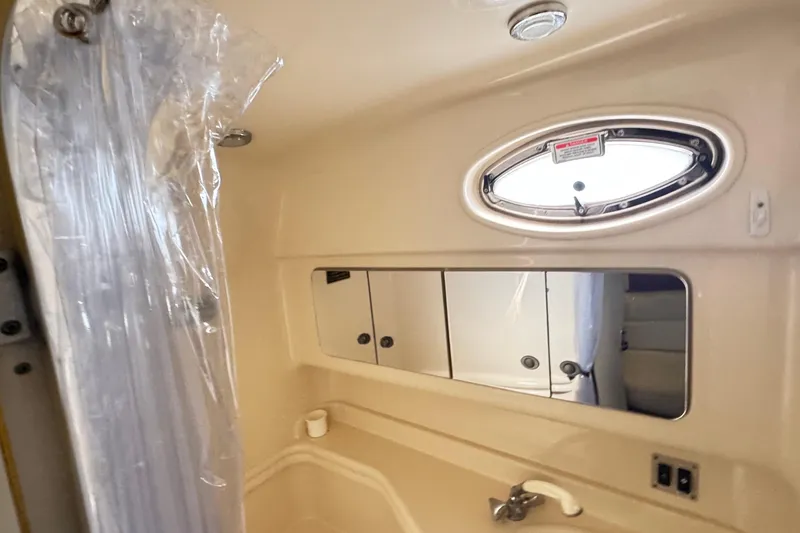  Yacht Photos Pics Bathroom interior of 2005 Sea Ray 340 Sundancer yacht with mirror and porthole.