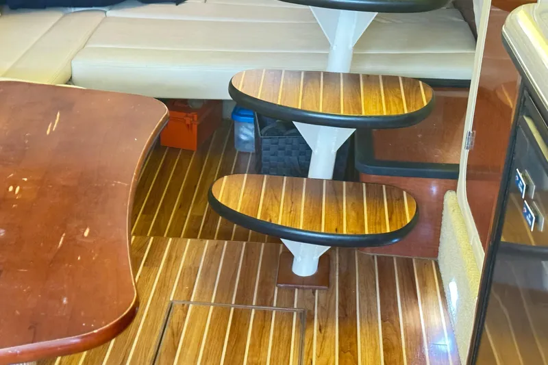  Yacht Photos Pics Interior of 2005 Sea Ray 340 Sundancer with wooden steps and seating area.