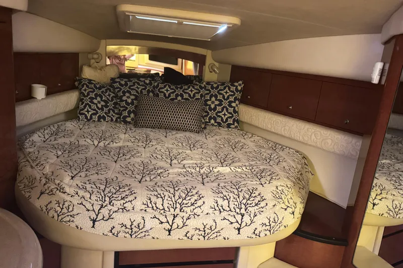  Yacht Photos Pics Luxurious cabin interior of 2005 Sea Ray 340 Sundancer with elegant bedding and wood cabinetry.