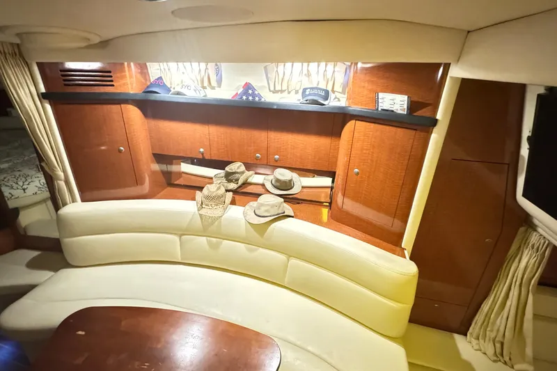  Yacht Photos Pics Interior of 2005 Sea Ray 340 Sundancer with curved seating and wooden cabinetry.