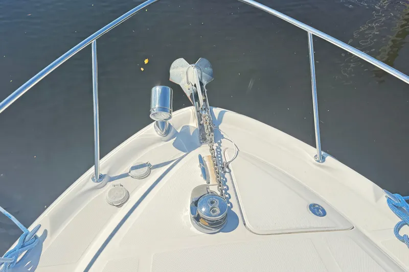  Yacht Photos Pics Bow of 2005 Sea Ray 340 Sundancer with anchor and railing on calm water.