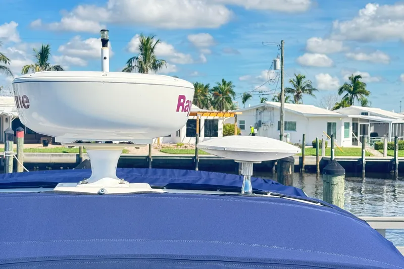  Yacht Photos Pics Radar equipment on a 2005 Sea Ray 340 Sundancer boat, docked near waterfront homes.