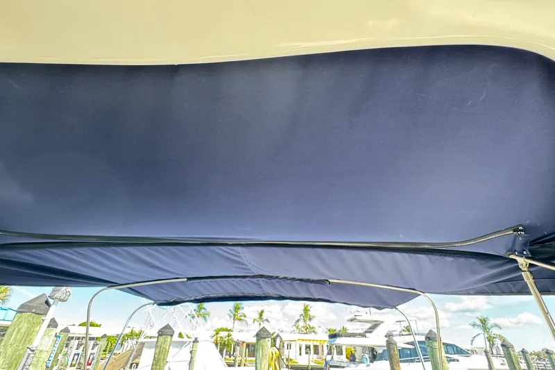  Yacht Photos Pics 2005 Sea Ray 340 Sundancer bimini top with marina view in background.