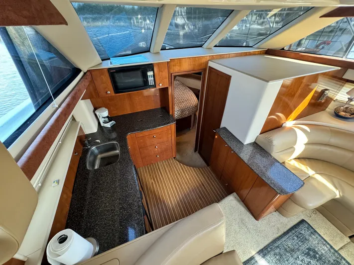 Full House Yacht Photos Pics 2006 Meridian 368 Motoryacht interior with modern kitchen and seating area.