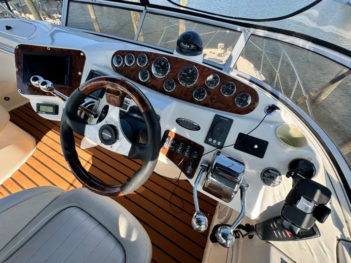 Full House Yacht Photos Pics Helm of 2006 Meridian 368 Motoryacht with wood accents and modern controls.
