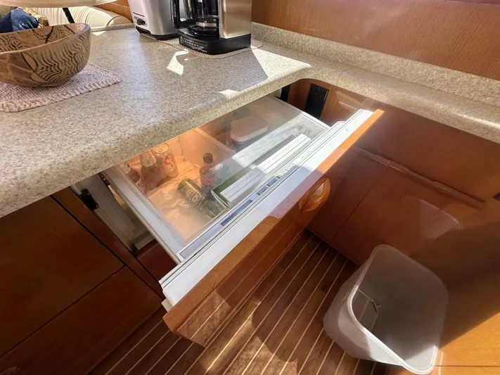 Gitana Yacht Photos Pics Kitchen area of 2000 Viking Enclosed Flybridge with open drawer fridge.