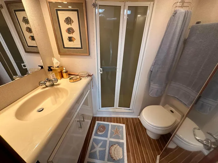 Gitana Yacht Photos Pics Bathroom interior of 2000 Viking Enclosed Flybridge yacht with nautical decor.