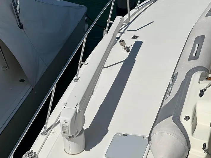 Gitana Yacht Photos Pics 2000 Viking Enclosed Flybridge deck with inflatable boat and railing.