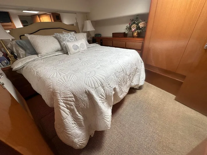 Gitana Yacht Photos Pics Luxurious bedroom interior of 2000 Viking Enclosed Flybridge yacht with elegant bedding.