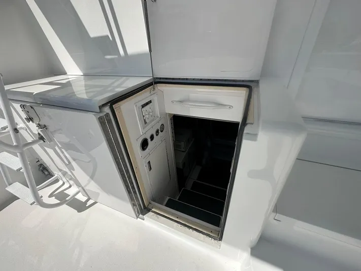 Gitana Yacht Photos Pics Hatch entrance on 2000 Viking Enclosed Flybridge yacht, showing interior stairs and control panel.