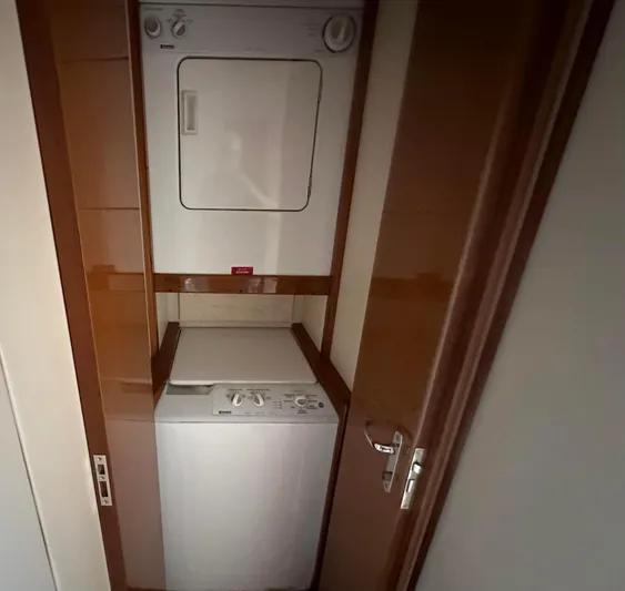 Gitana Yacht Photos Pics Stacked washer and dryer in 2000 Viking Enclosed Flybridge yacht interior.