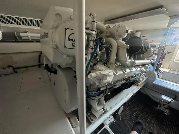 Gitana Yacht Photos Pics Engine room of a 2000 Viking Enclosed Flybridge yacht, featuring a powerful marine diesel engine.