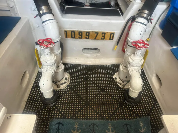 Gitana Yacht Photos Pics Engine room of a 2000 Viking Enclosed Flybridge with visible piping and valves.