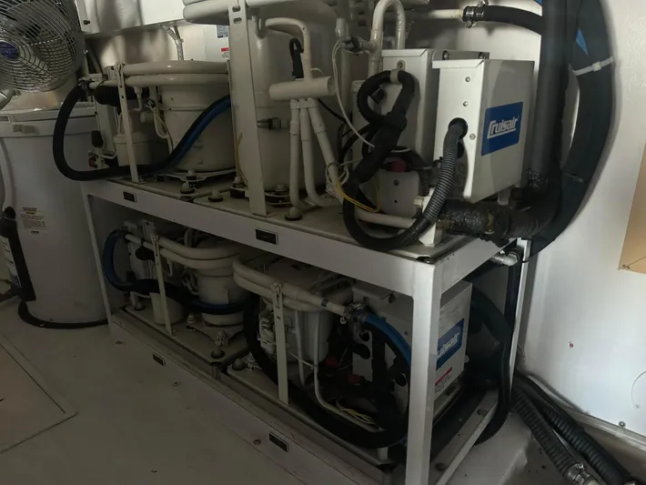 Gitana Yacht Photos Pics Engine room of a 2000 Viking Enclosed Flybridge yacht with mechanical equipment and piping.