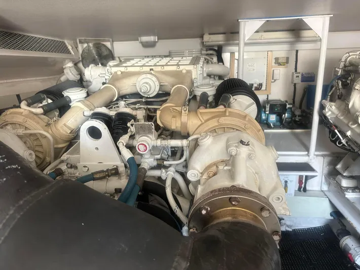 Gitana Yacht Photos Pics Engine room of a 2000 Viking Enclosed Flybridge yacht, showcasing complex machinery and components.