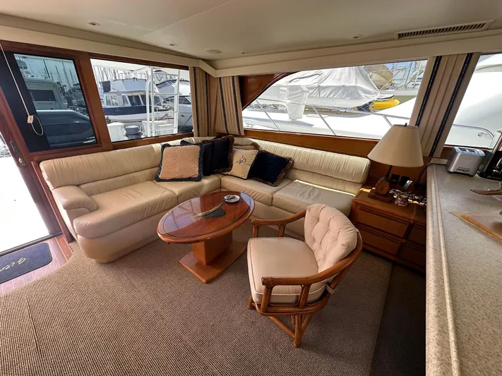 Gitana Yacht Photos Pics Luxurious interior of 2000 Viking Enclosed Flybridge yacht with plush seating and elegant decor.