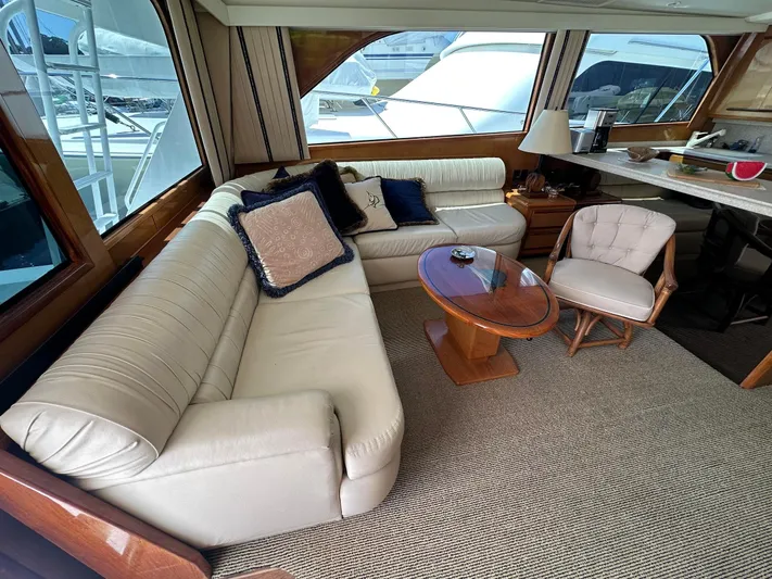 Gitana Yacht Photos Pics Luxurious interior of 2000 Viking Enclosed Flybridge yacht with plush seating and elegant decor.