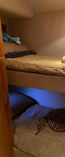  Yacht Photos Pics Bunk beds in 2005 Hatteras 50 Convertible yacht cabin, featuring cozy bedding and soft lighting.