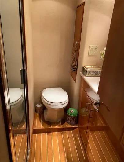  Yacht Photos Pics Bathroom interior of 2005 Hatteras 50 Convertible yacht with wooden flooring.