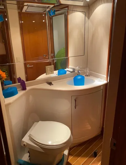  Yacht Photos Pics Bathroom interior of 2005 Hatteras 50 Convertible yacht, featuring modern fixtures and wood accents.