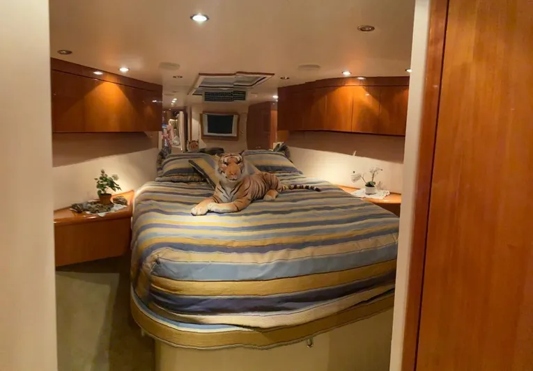  Yacht Photos Pics Luxurious bedroom in 2005 Hatteras 50 Convertible yacht with plush bedding and tiger plush toy.