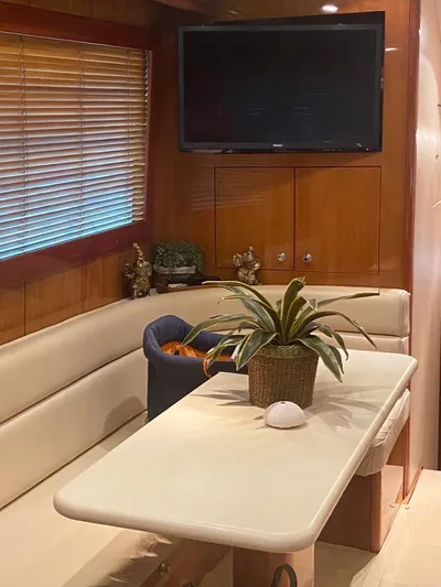  Yacht Photos Pics Interior of 2005 Hatteras 50 Convertible yacht with seating, table, and TV.