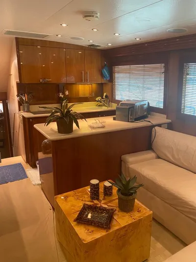  Yacht Photos Pics Luxurious interior of a 2005 Hatteras 50 Convertible yacht with modern kitchen and seating area.