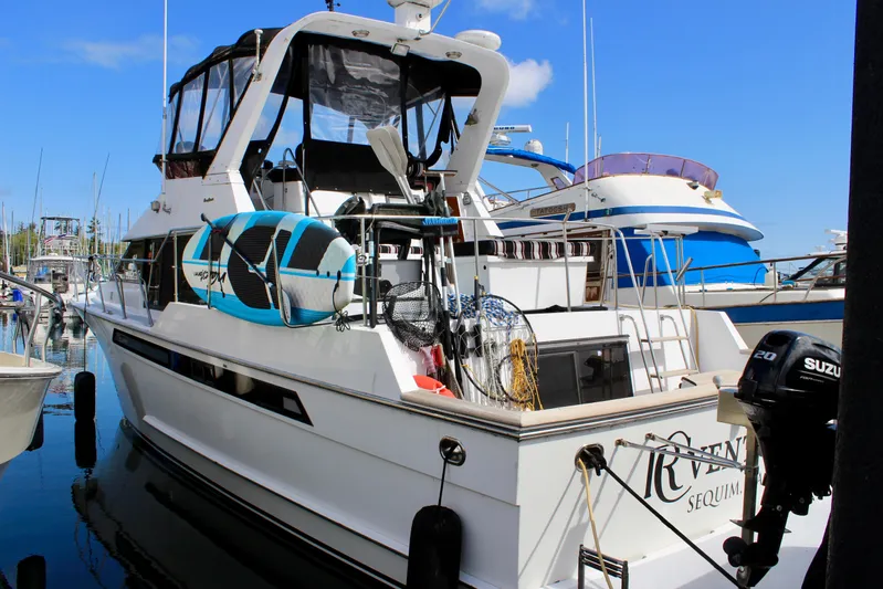 Rc Venture Yacht Photos Pics 1989 Ocean Alexander 44 yacht docked, featuring outdoor gear and a Suzuki outboard motor.