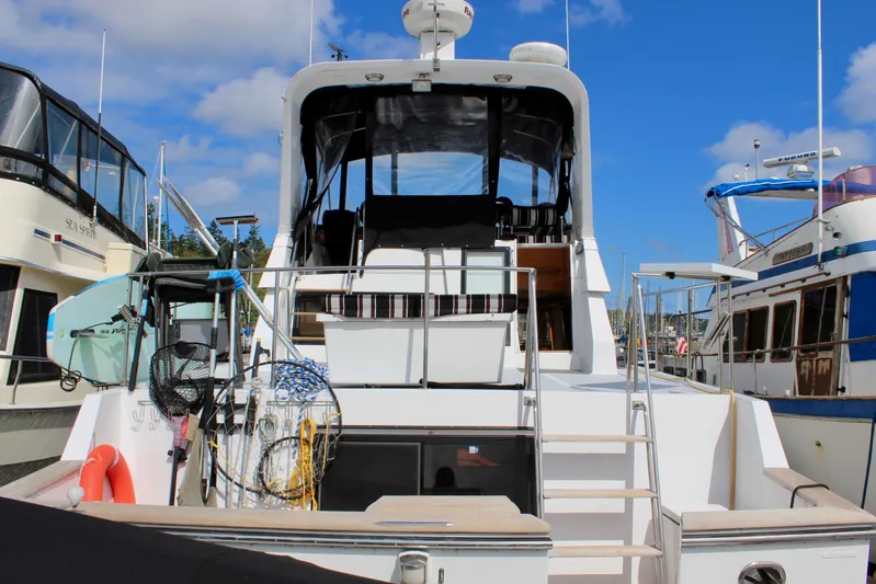 Rc Venture Yacht Photos Pics 1989 Ocean Alexander 44 yacht docked, featuring spacious deck and seating under clear blue sky.