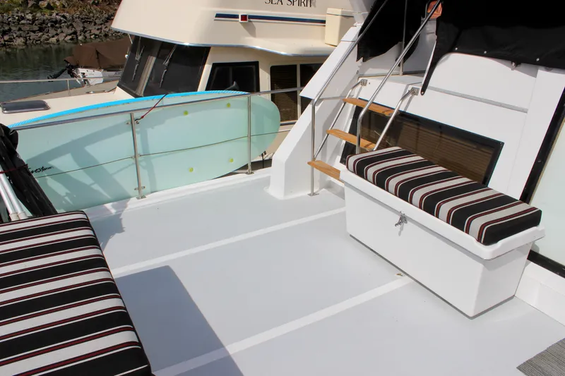 Rc Venture Yacht Photos Pics Ocean Alexander 44 yacht deck with striped seating and surfboard, 1989 model.