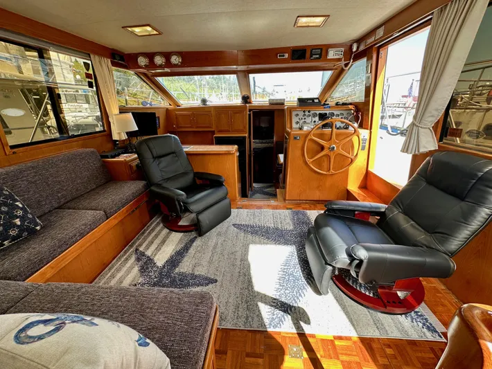 Rc Venture Yacht Photos Pics Interior of 1989 Ocean Alexander 44 yacht with plush seating and wooden helm.