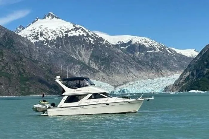  Yacht Photos Pics Bayliner 3988 Command Bridge Motoryacht, 1999, cruising near snow-capped mountains and glacier.