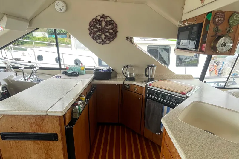  Yacht Photos Pics Interior of 1999 Bayliner 3988 Motoryacht kitchen with appliances and countertop.