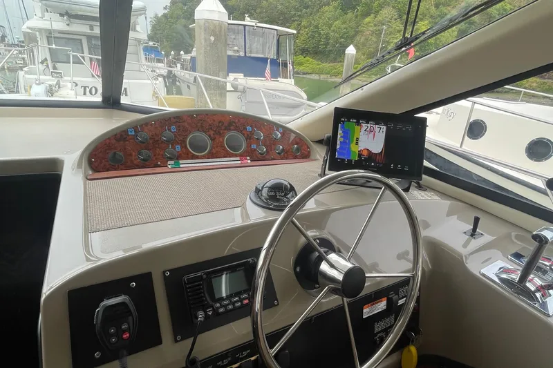  Yacht Photos Pics 1999 Bayliner 3988 Motoryacht helm with steering wheel, navigation display, and control panel.