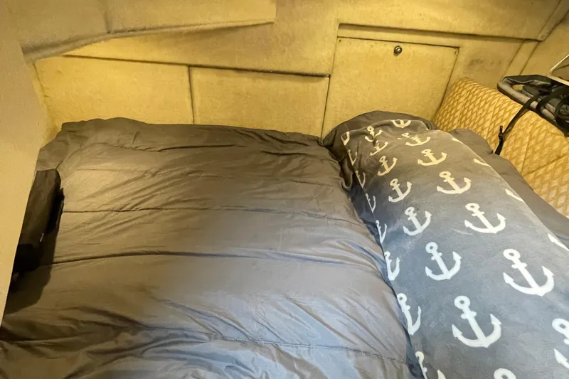  Yacht Photos Pics Cozy cabin bed in 1999 Bayliner 3988 Motoryacht with anchor-patterned blanket.